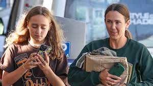 Bec Hewitt shows off her age-defying visage as she runs errands makeup free with daughter Ava